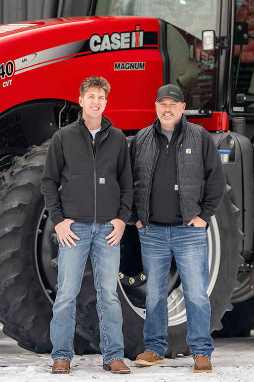 Mark and his son standing infront of a Case IH Tractor