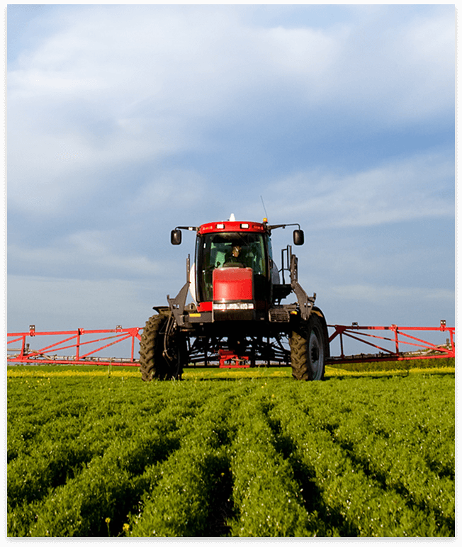 Tractor with a sprayer in a field